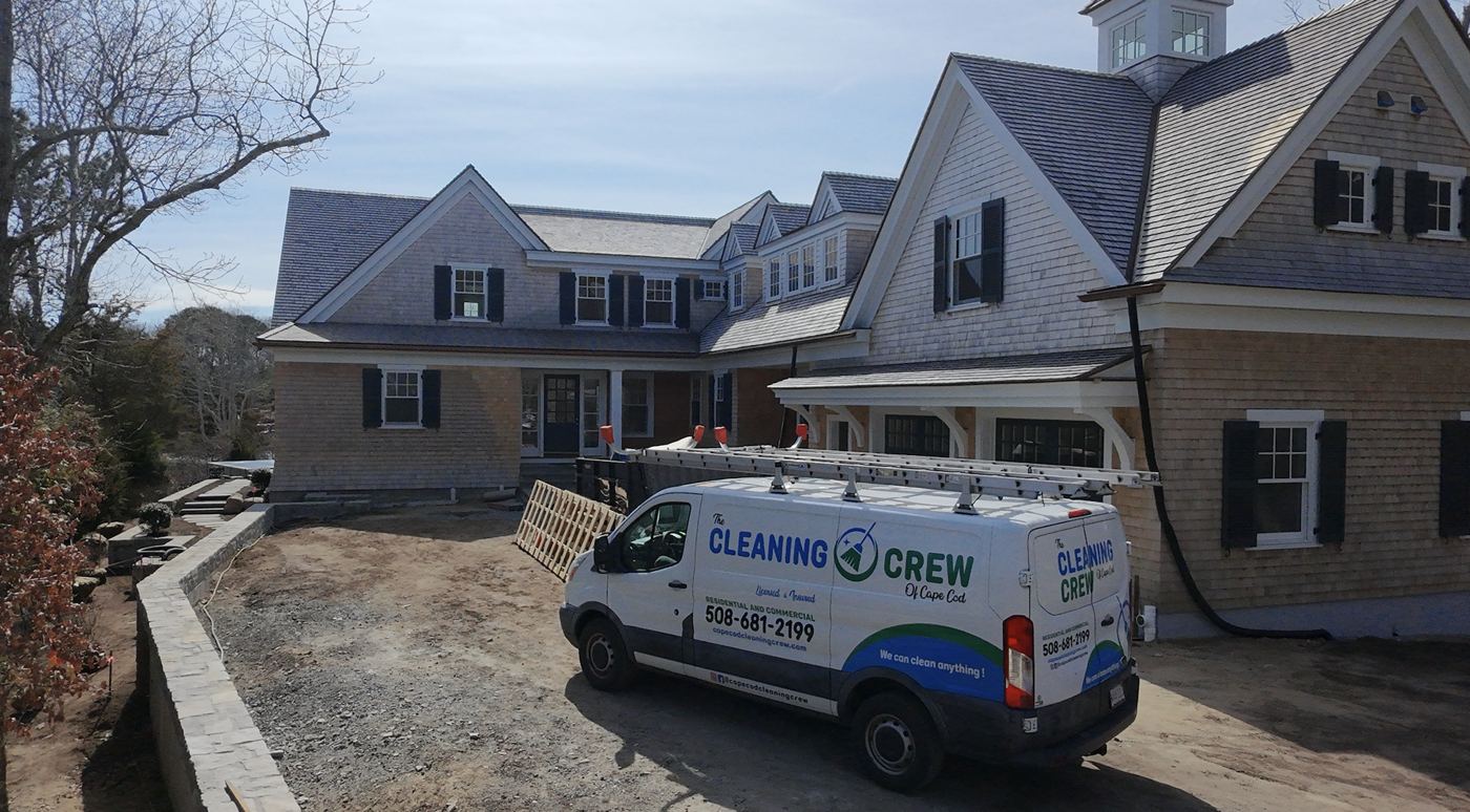 Crew van in front of a large shingle-style home with a cupola