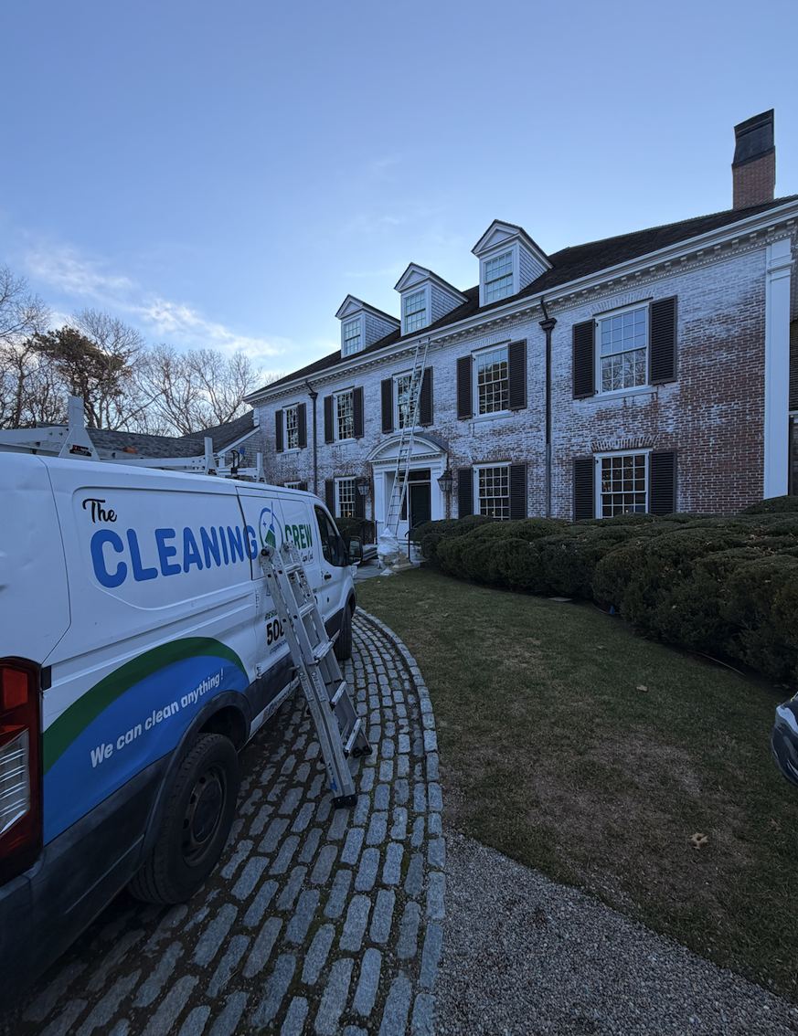 Ladder at a brick colonial during a window cleaning